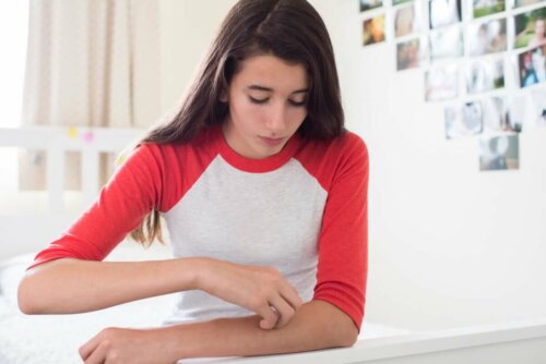 Teenager itching arm.