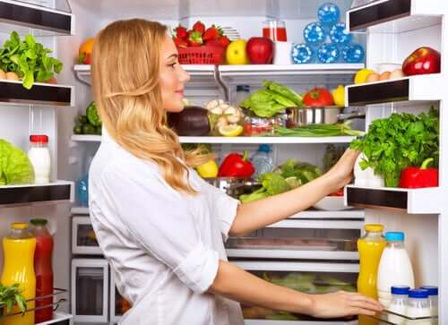 Woman looking in fridge.