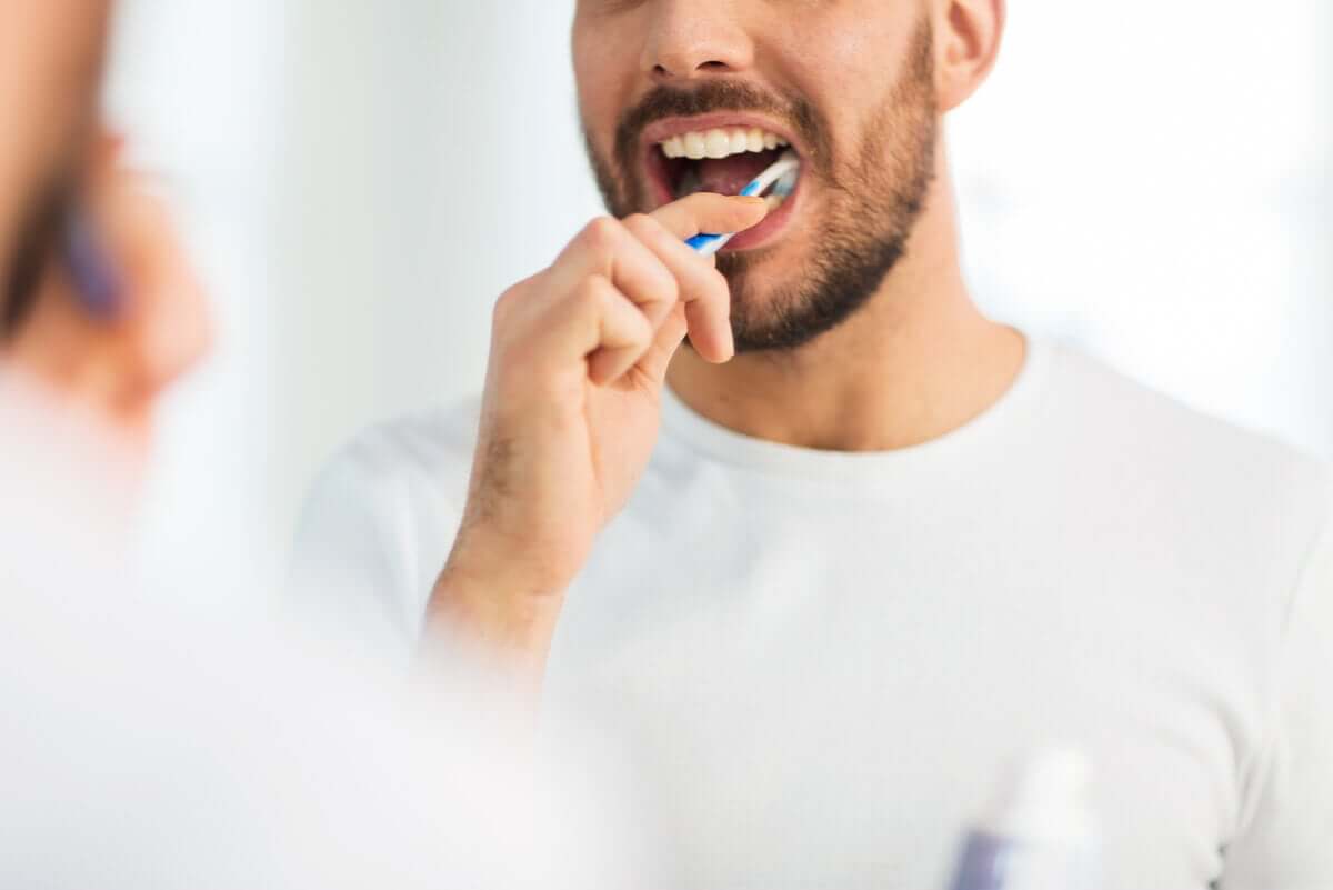 A man brushing teeth.