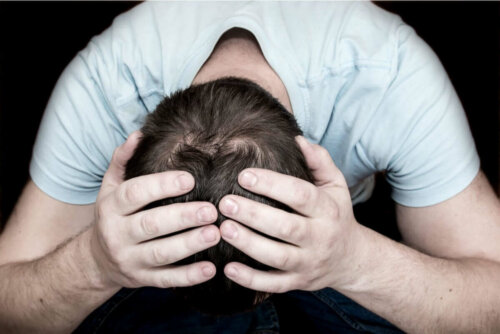 depressed man with his head in his hands