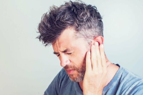 man with ear pain caused by vertigo