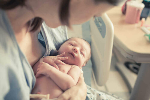 A newborn baby with their mother.