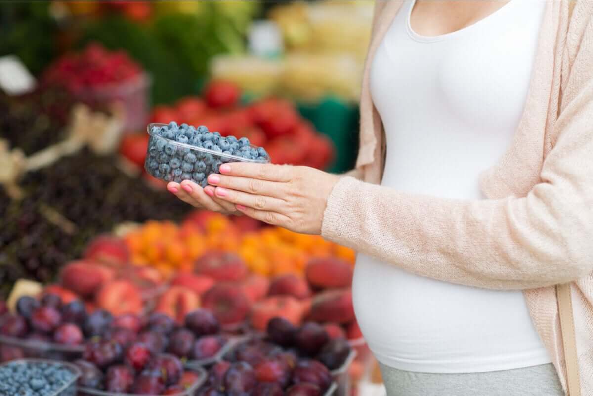 Pregnant woman with berries.