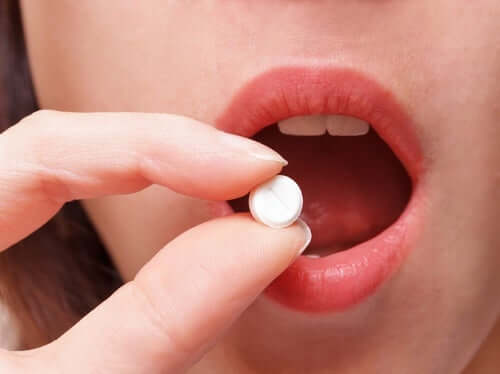 A person taking a pill.
