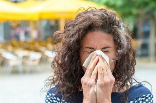 A woman blowing her nose.