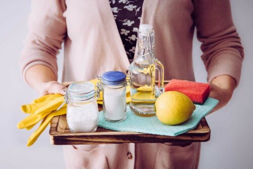 A woman with a tray of cleaning products.