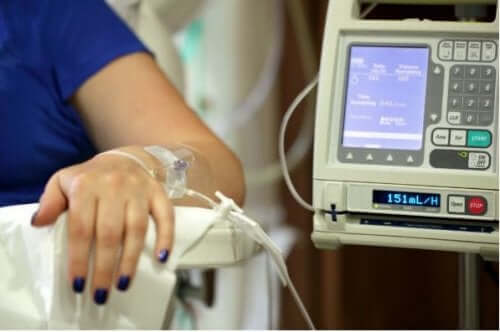 A woman connected to a chemotherapy machine.