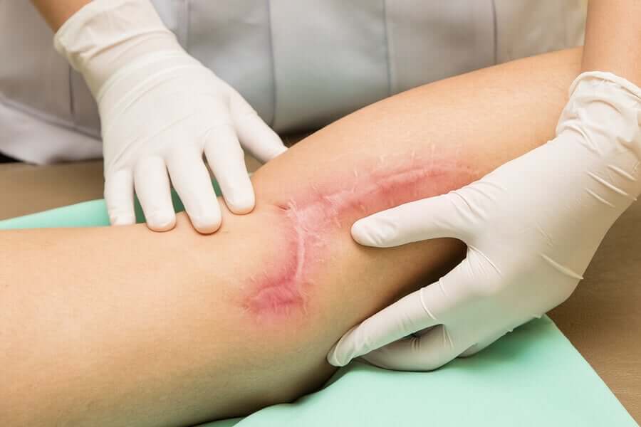 Doctor looking at leg.