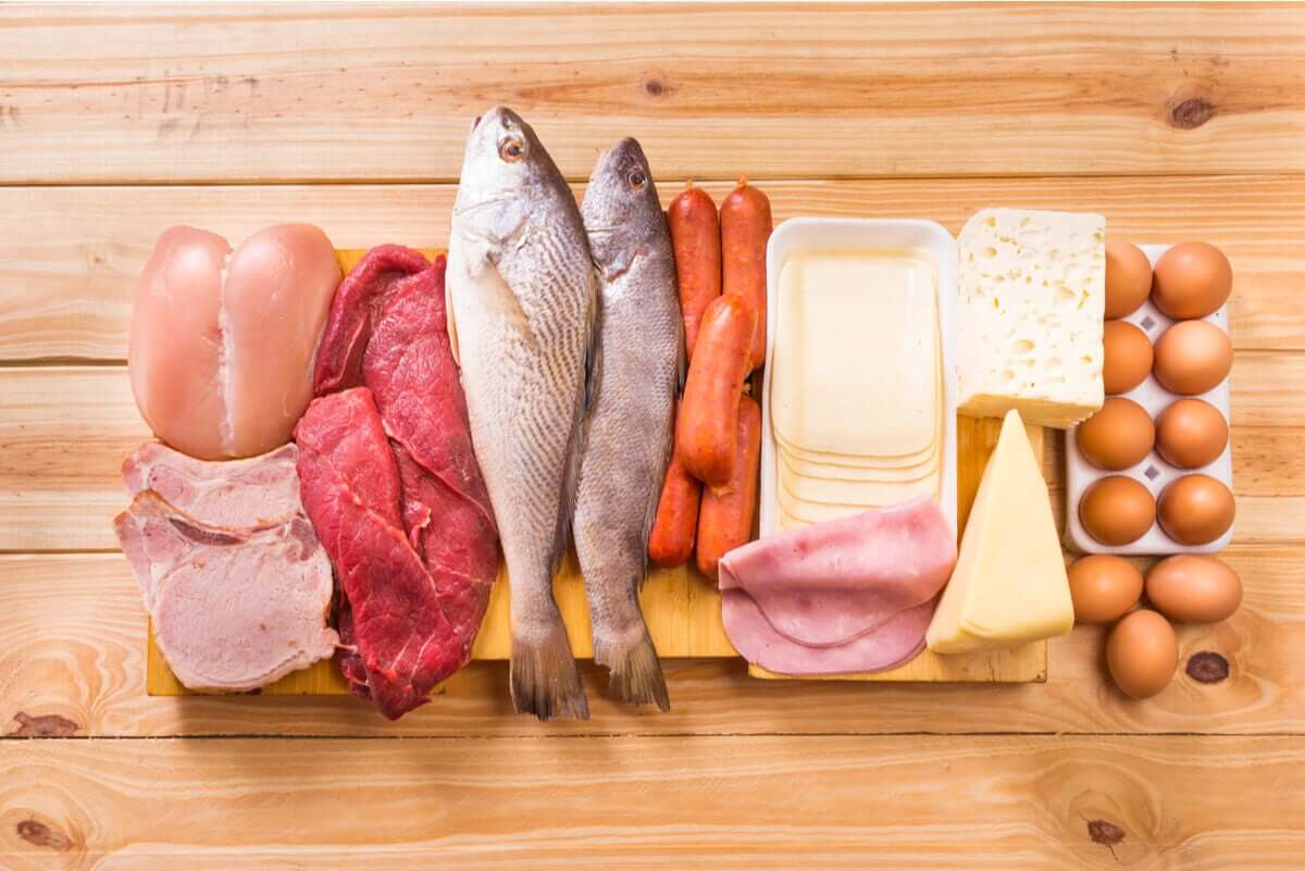 Different types of animal-based products, incudling chicken, pork, beef, fish, sausages, cheeses, deli ham, and eggs.