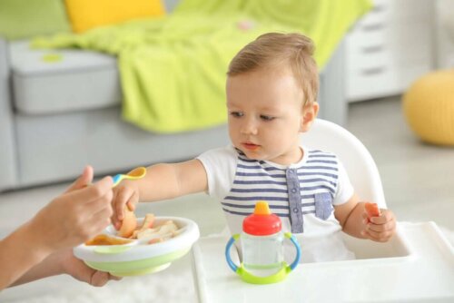 A baby eating new foods.