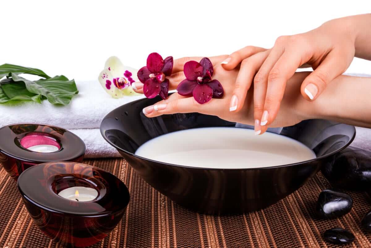 Woman using buttermilk mask on her hands.