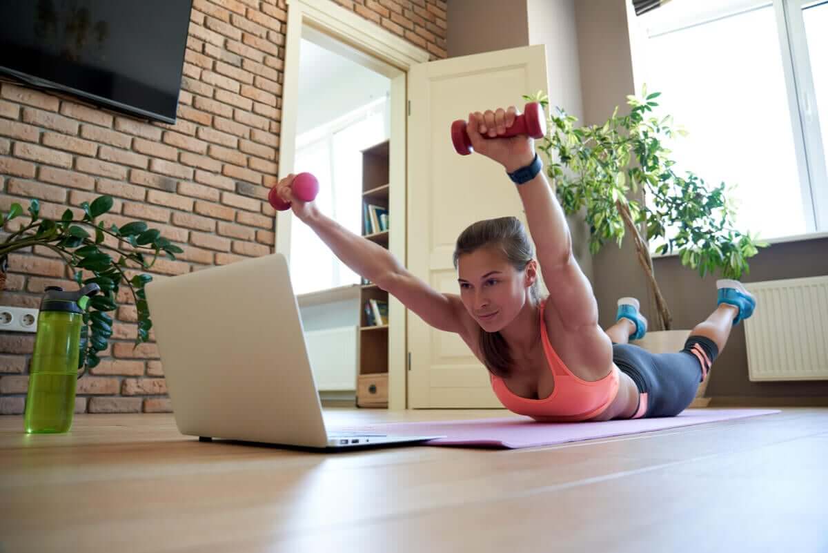 A woman doing the superman exercise.