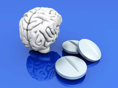 A digital image of a white brain next to three white pills against a blue background.