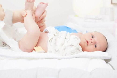 A person changing a baby's diaper.