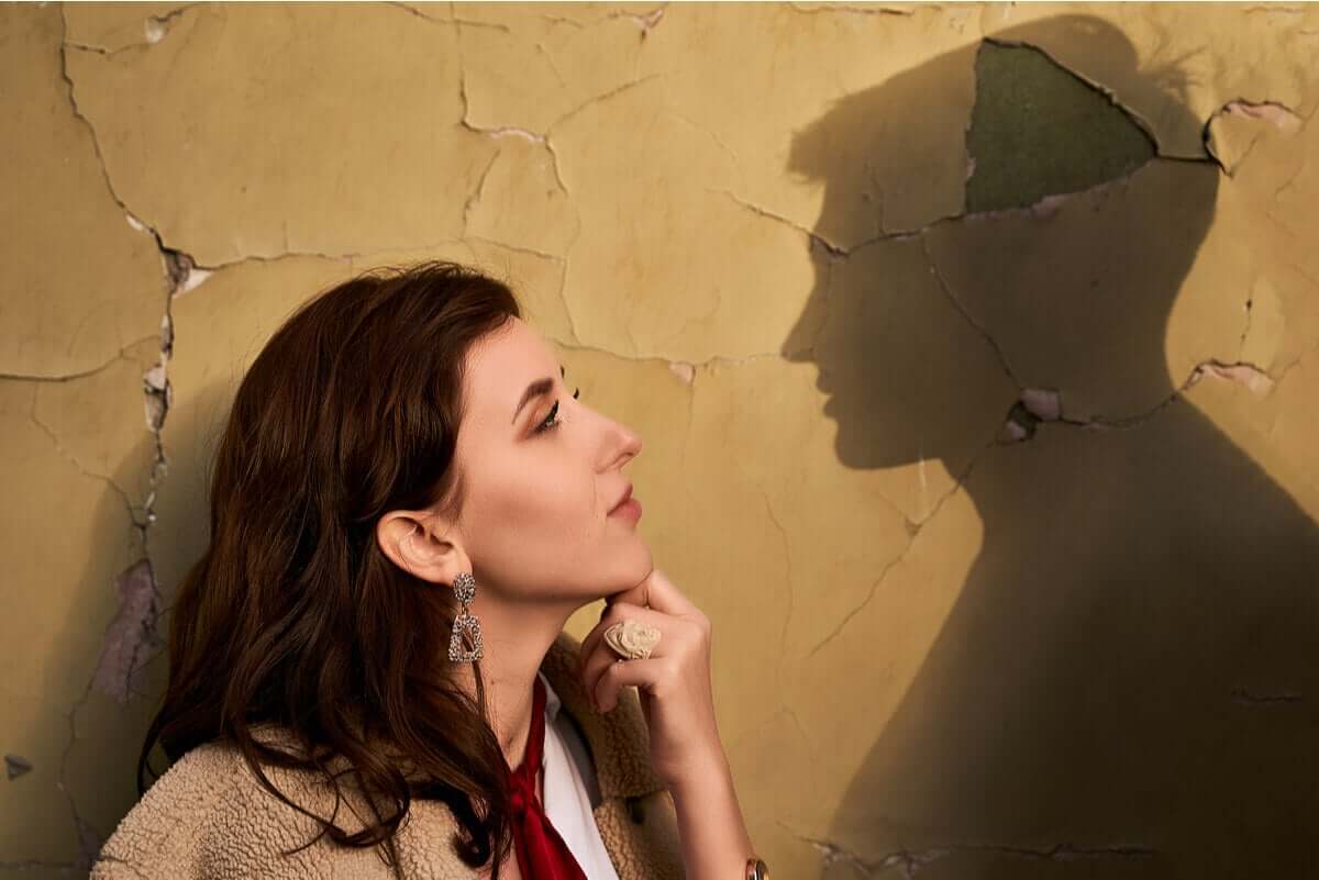 A woman looking longingly into the silhouette of her ex.