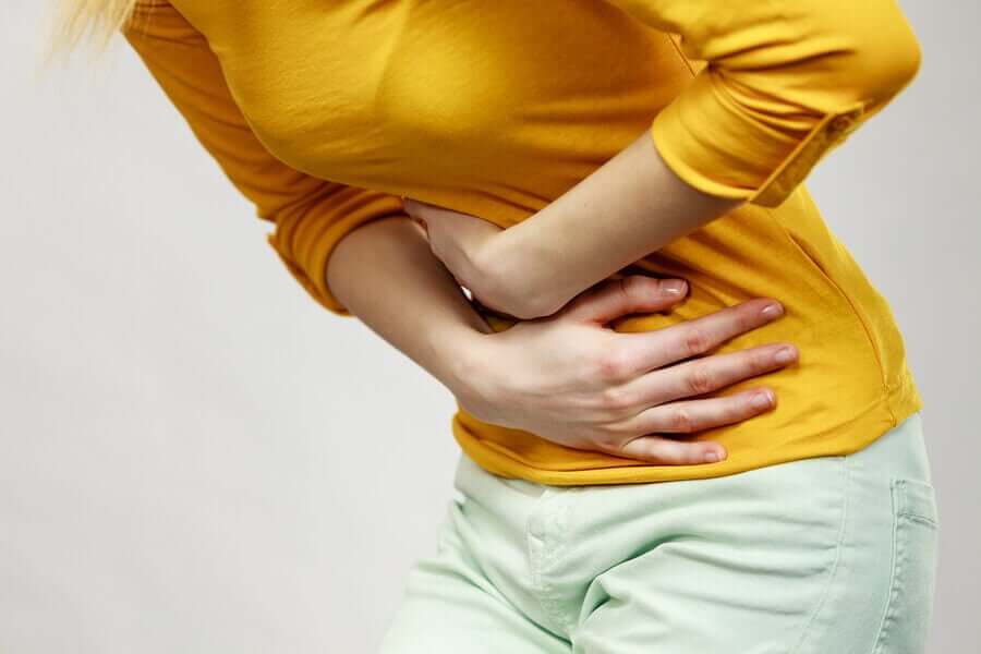 A woman clutching her stomach.