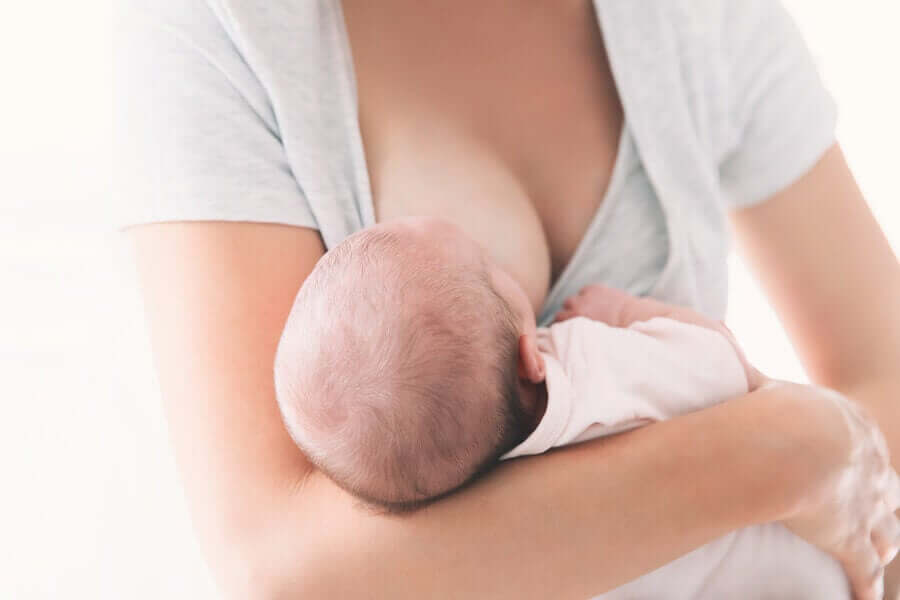 A woman breastfeeding her small baby.