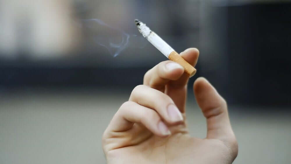 Hand with cigarette.