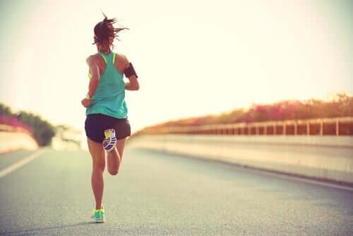 A woman running down the road by herself.