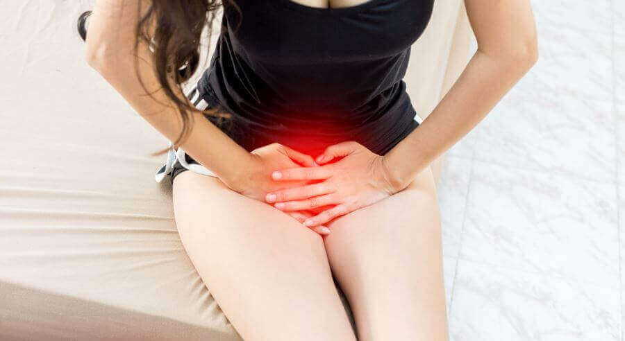 A woman with hands in her lap.