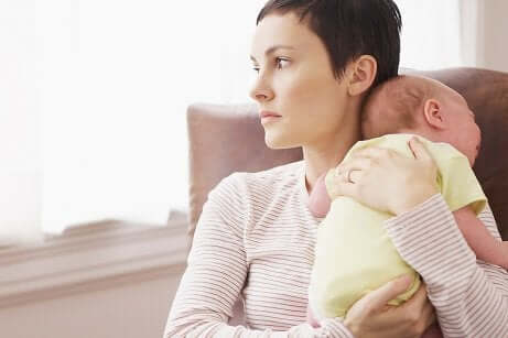 A woman is holding her baby. 