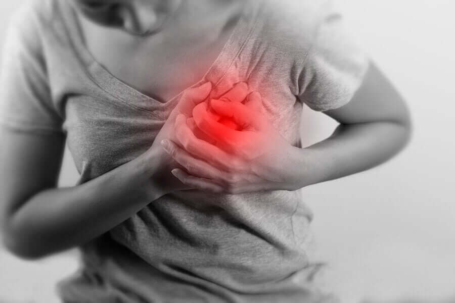 A woman clutching her chest in pain.