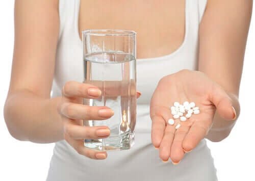 A woman taking pills.