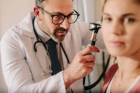A doctor looking in his patient's ear.