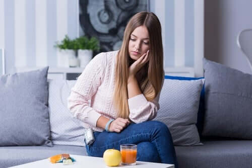 A woman looking at the food on a table.