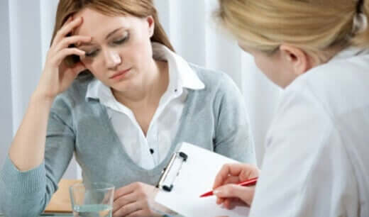 A worried woman with a doctor.