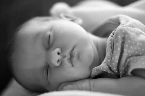A newborn sleeping on her belly.