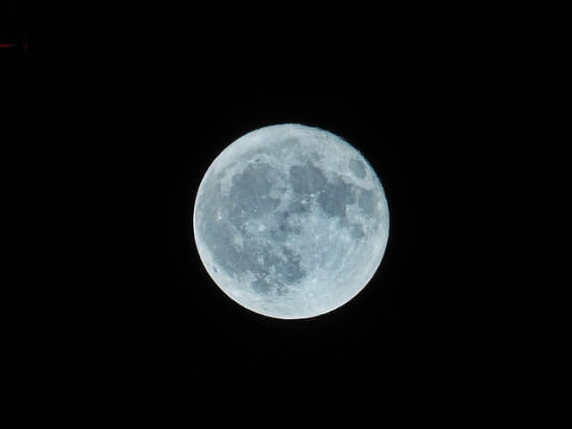 A picture of the moon in the middle of a black sky.