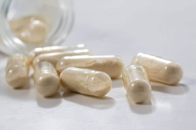 Weight-loss pills spilling out of a bottle.