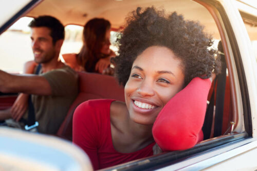 Going on a trip may be a good solution when you don't feel like doing anything. In this photo, a woman feeling happy while on a road trip with friends.