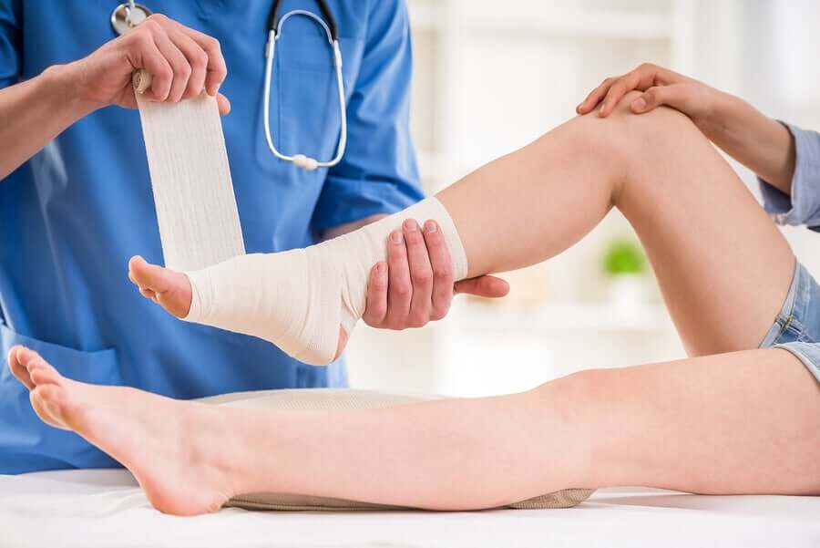 A doctor fixing a sprained ankle.