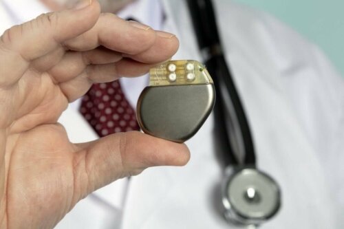 A doctor holding a pacemaker.