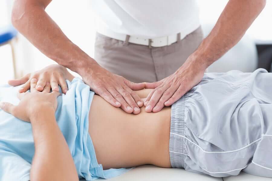 A doctor pressing down on a stomach