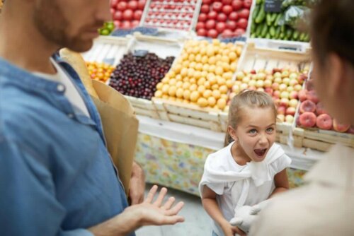 A girl misbehaving at the grocery store.