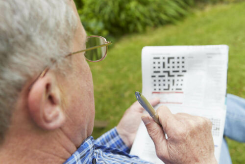 A man doing a crossword puzzle.