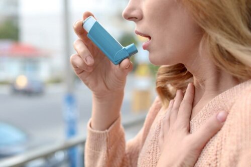 A woman using an inhaler.