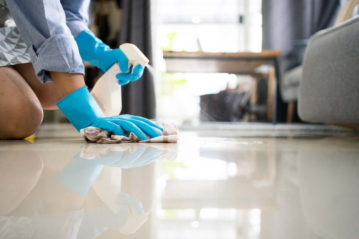 A woman scrubbing the floor.