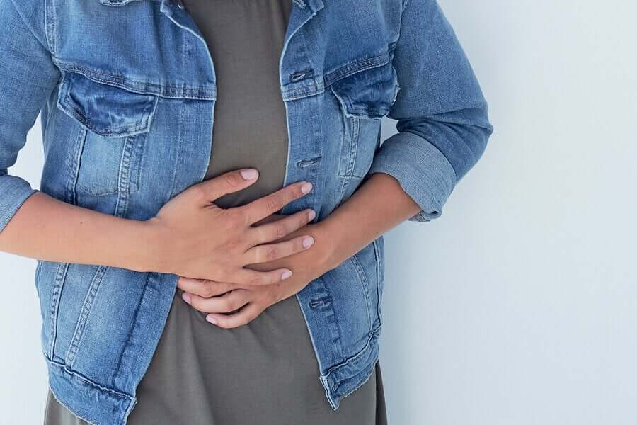 A woman holding her abdomen.