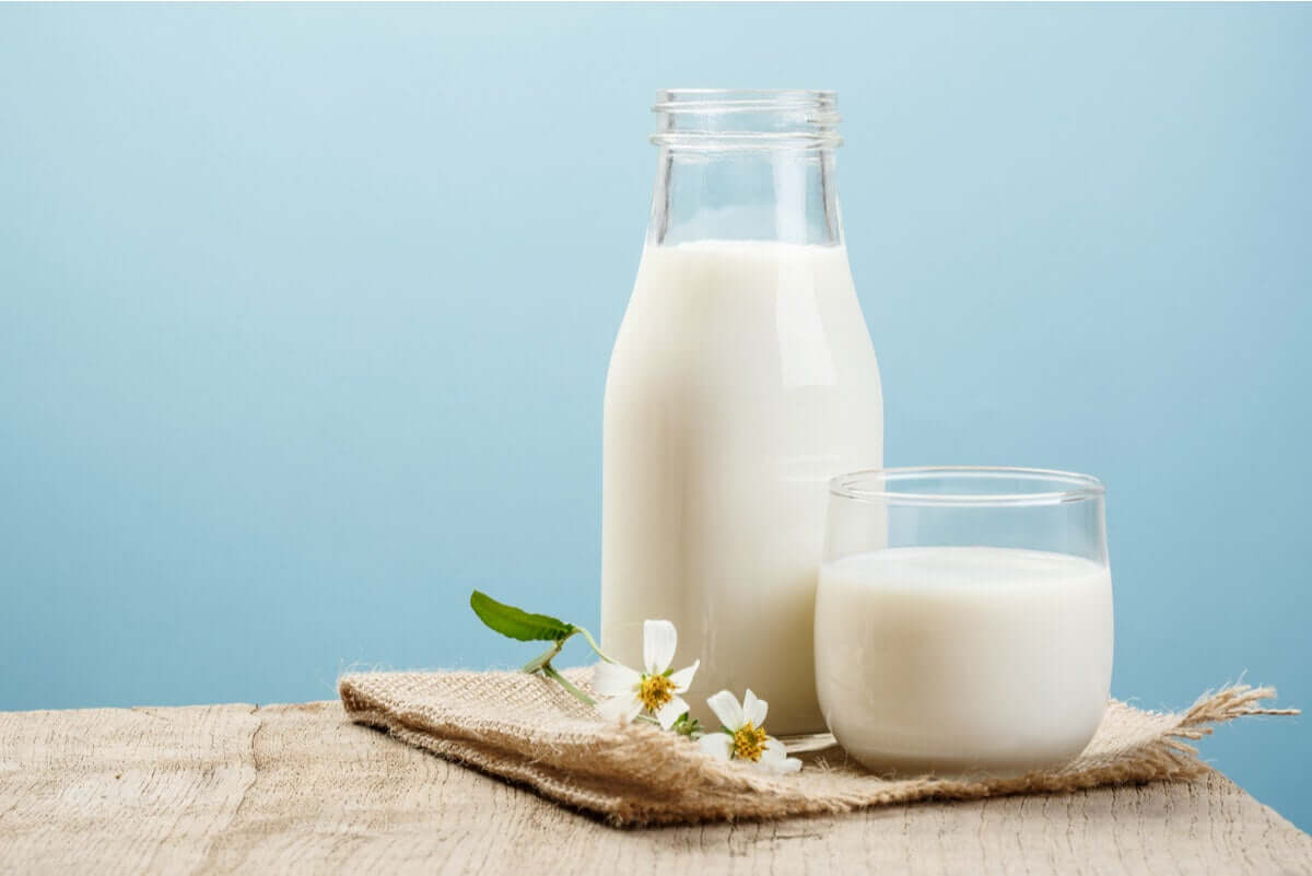 A jar of milk and a glass of milk.