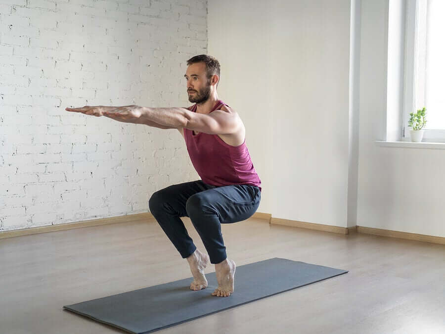 A man doing squats while on his tip toes.