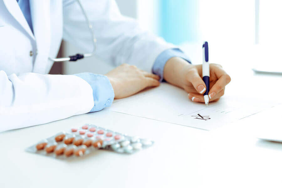 A female doctor writing a prescription.