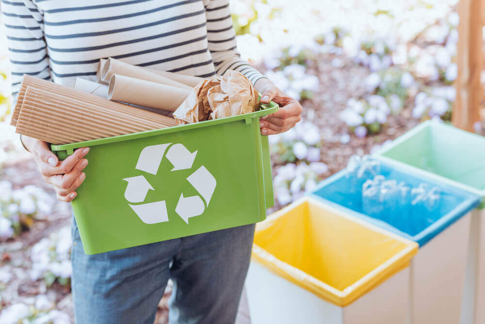 A woman sorting her recycleable.