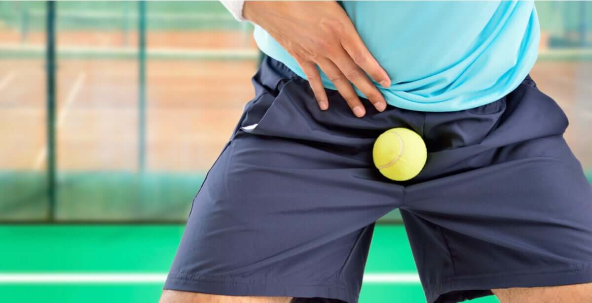 A man getting hit in the testicles with a tennis ball.