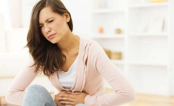 A woman with stomach pain.