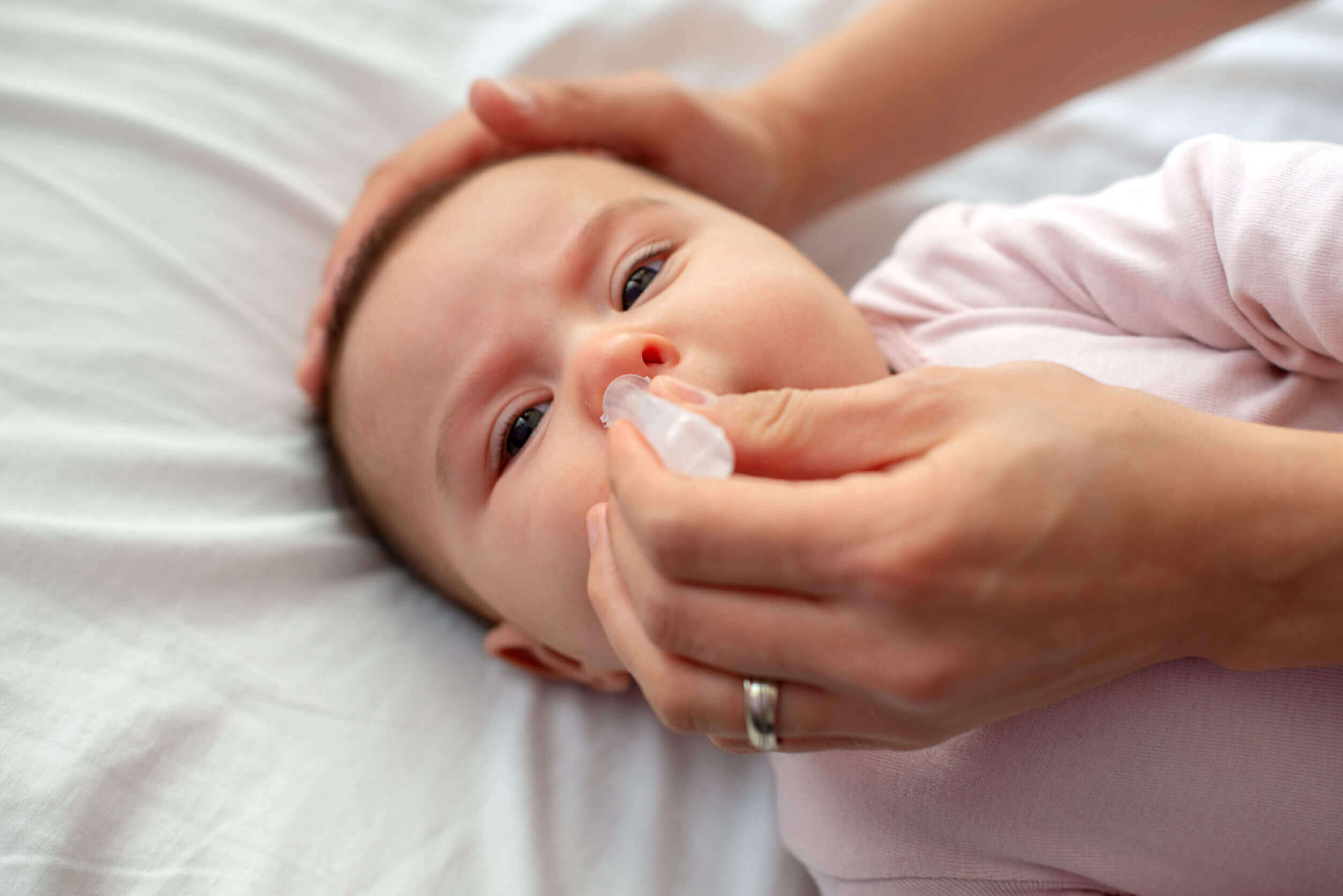 A baby getting a nasal irrigation.