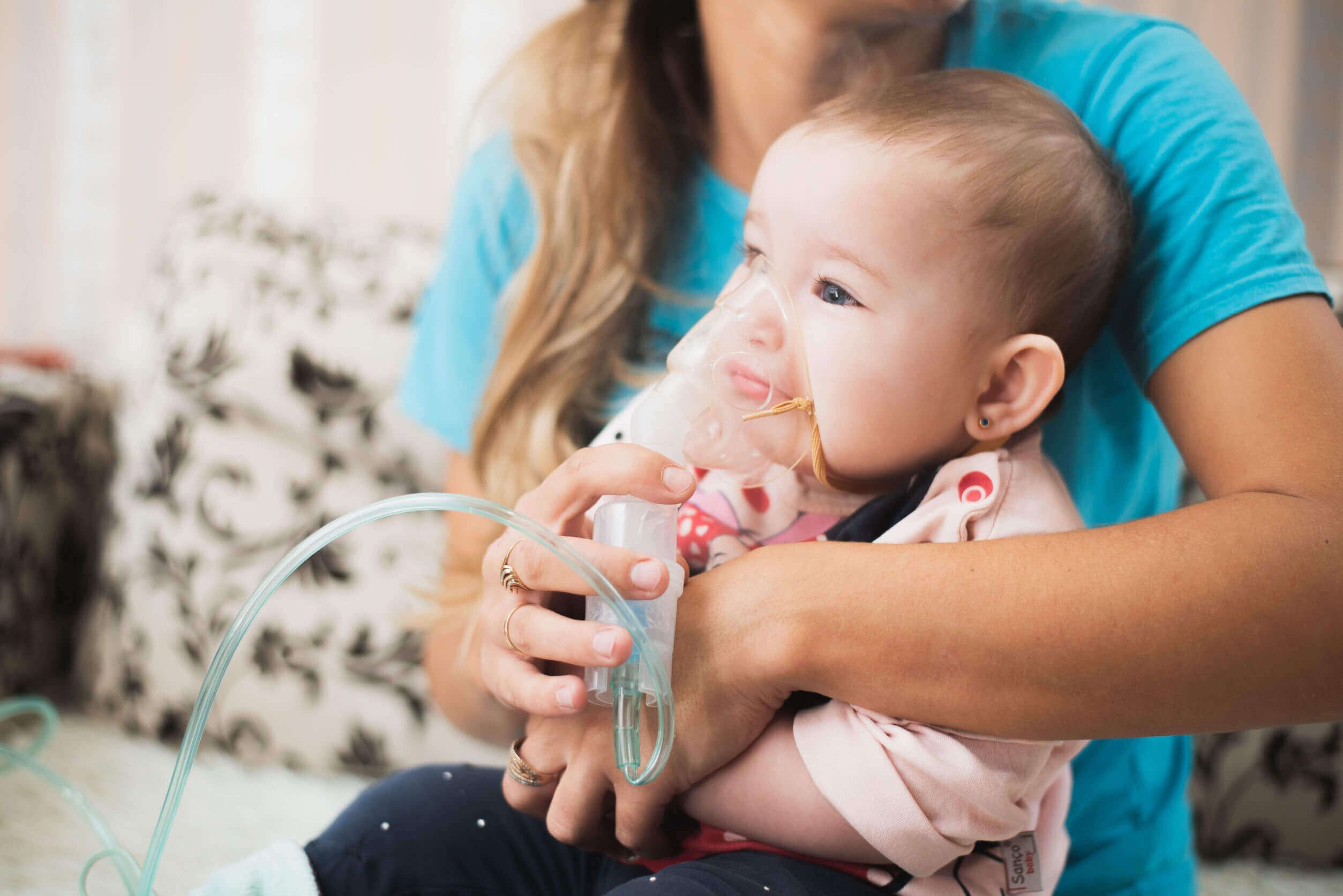 A baby wearing an oxygen mask.